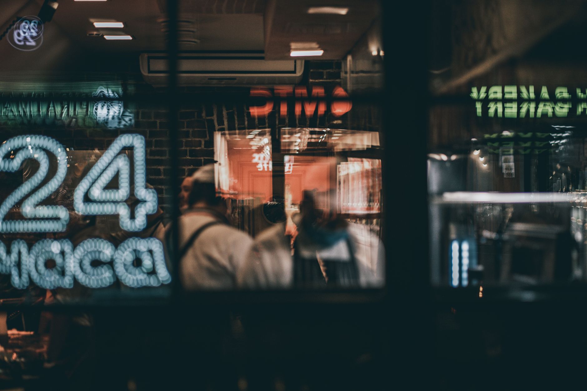 Step 3: Choose H.264 codec and container: Blurred view through cafe window, capturing a night scene with people inside. Warm, inviting atmos