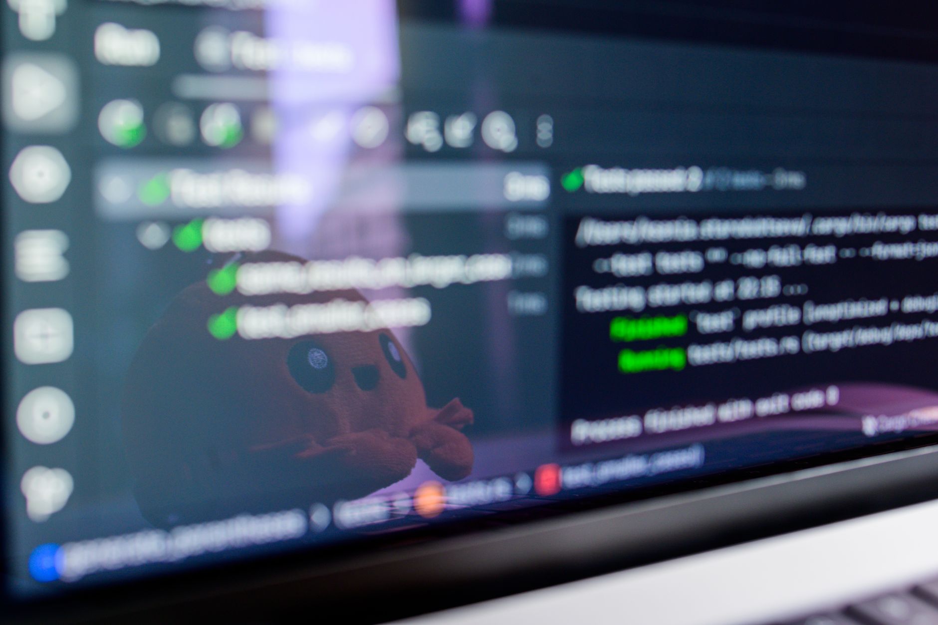 A GitHub repo brings LiDAR rooms into Three.js: Close-up of a laptop screen displaying programming code with a cute plush toy reflecting.